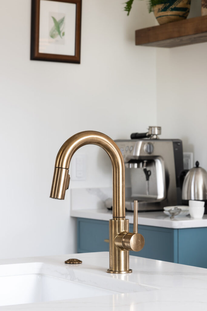 Prep sink and coffee station in Fairfax VA kitchen remodel with Delta Trinsic Champagne Bronze faucet, quartz countertops, custom storage cabinetry, and convenient beverage preparation area.